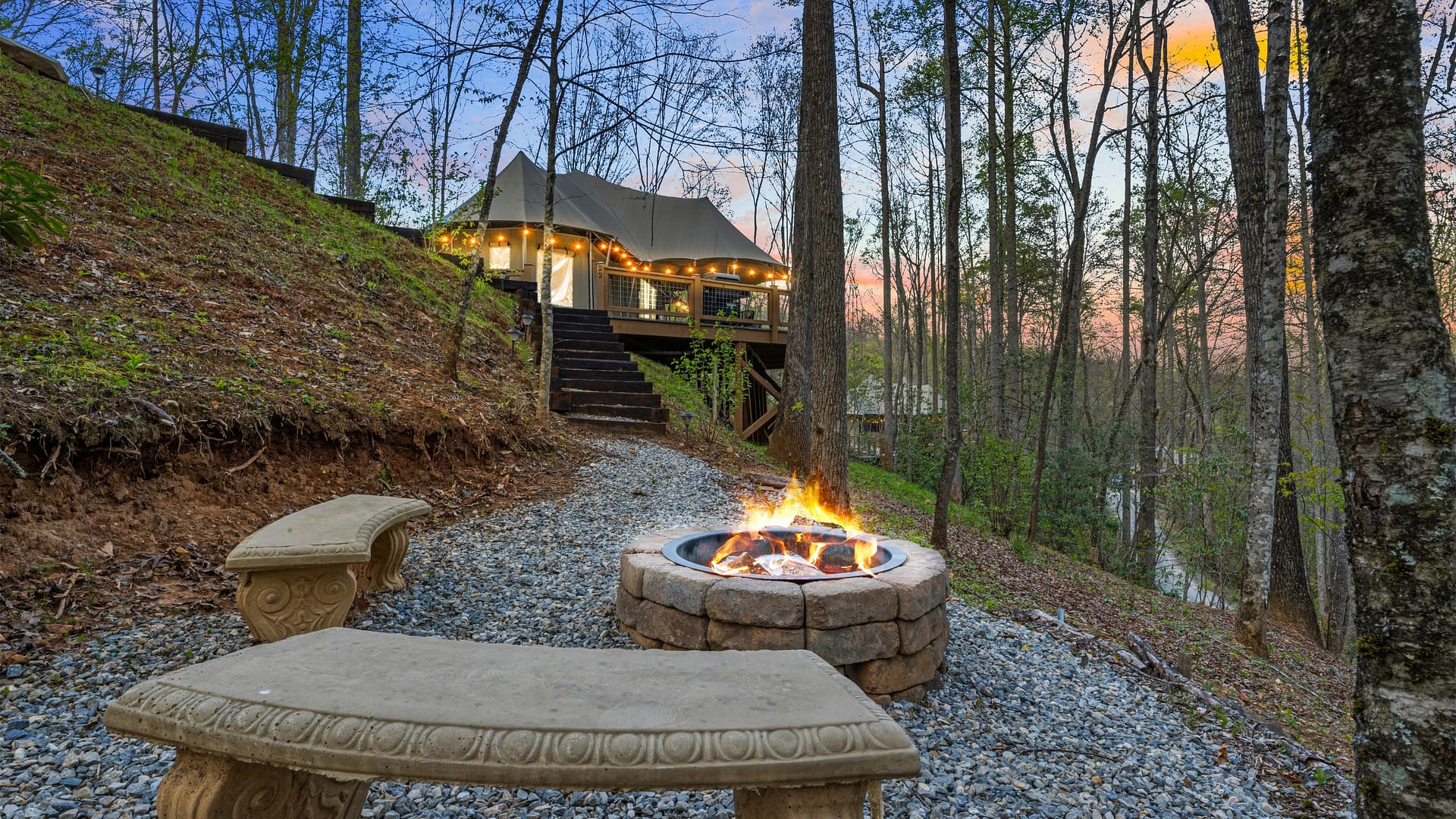 Elk Hollow Resort luxury safari tent glowing at dusk in the Great Smoky Mountains, Bryson City NC
